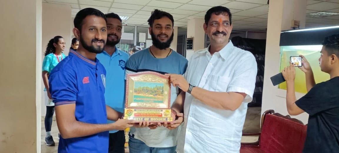 Players receive a framed award from a guest