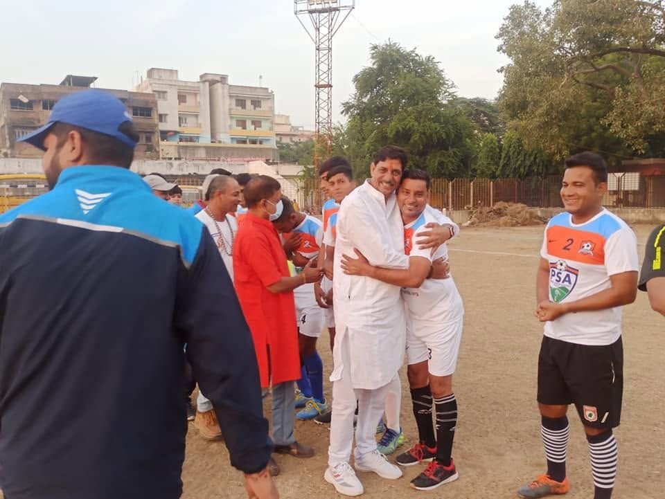 A guest greets players on the ground
