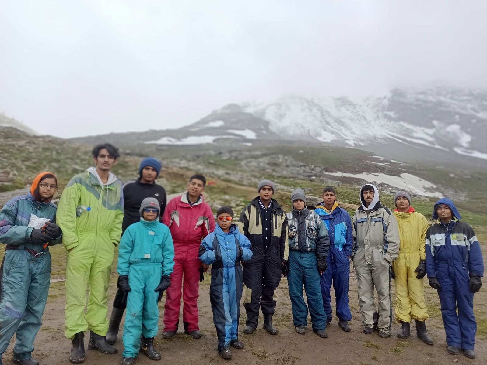 Players in snow suits on a mountain trip